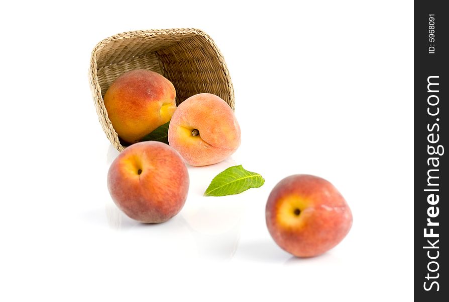 Ripe peaches falling from a basket