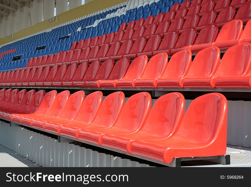 Free Seats on a tribune of stadium of yellow and dark blue color. Free Seats on a tribune of stadium of yellow and dark blue color