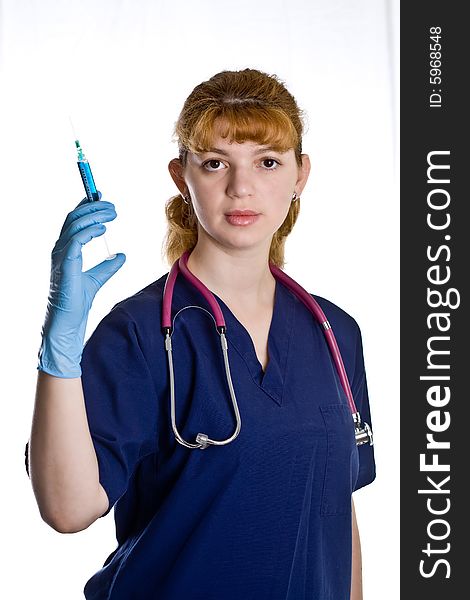 Female doctor with stethoscope and syringe over white background