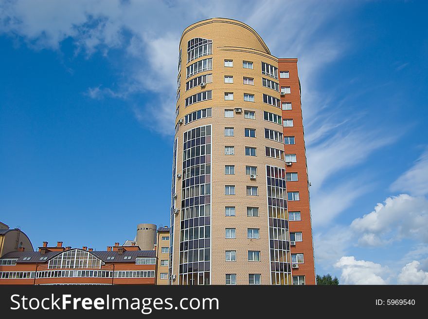 Multistory housing estate of red and yellow bricks in blue sky. Multistory housing estate of red and yellow bricks in blue sky