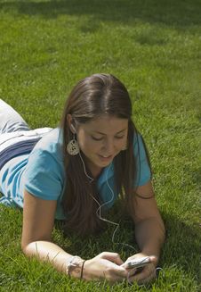 Girl In Grass Listening To Music Stock Photo Girl In Grass Listening To Music Stock Photo