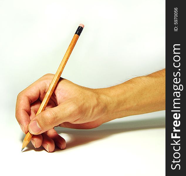 A hand holding a pencil contrasting a white background. A hand holding a pencil contrasting a white background