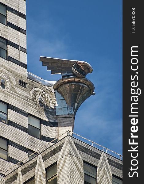 Chrystler Building eagle from the side against blue sky. Chrystler Building eagle from the side against blue sky