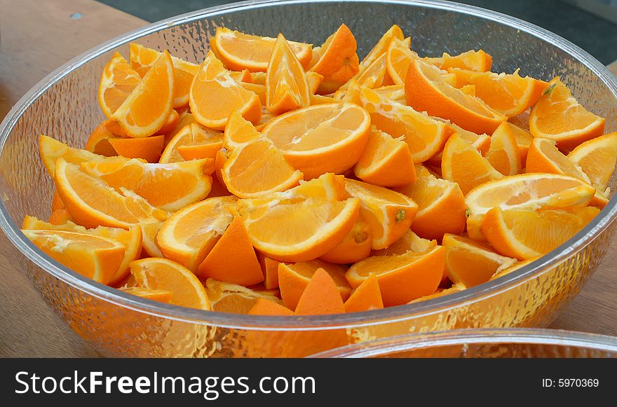 Oranges sliced into Quarters and Halves in a Bowl. Oranges sliced into Quarters and Halves in a Bowl