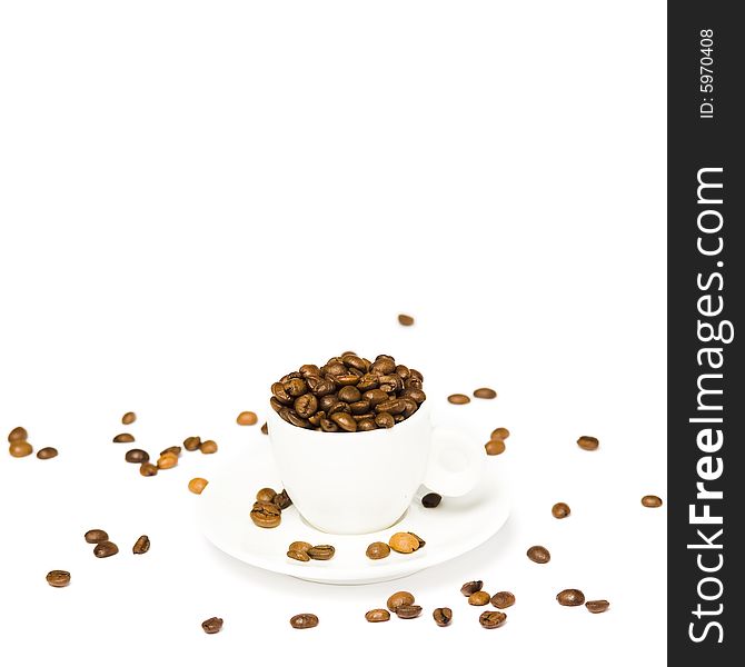 A white cup with coffee beans on white background