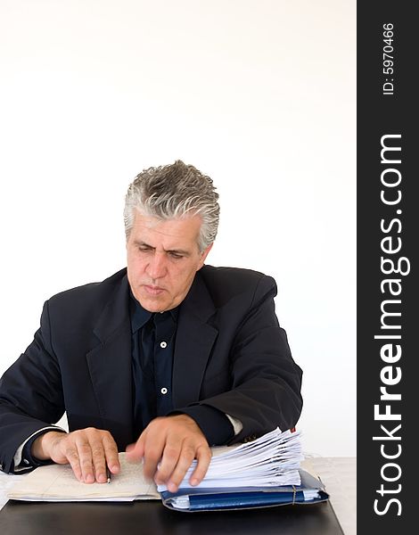 A businessman at work in his office writing a report