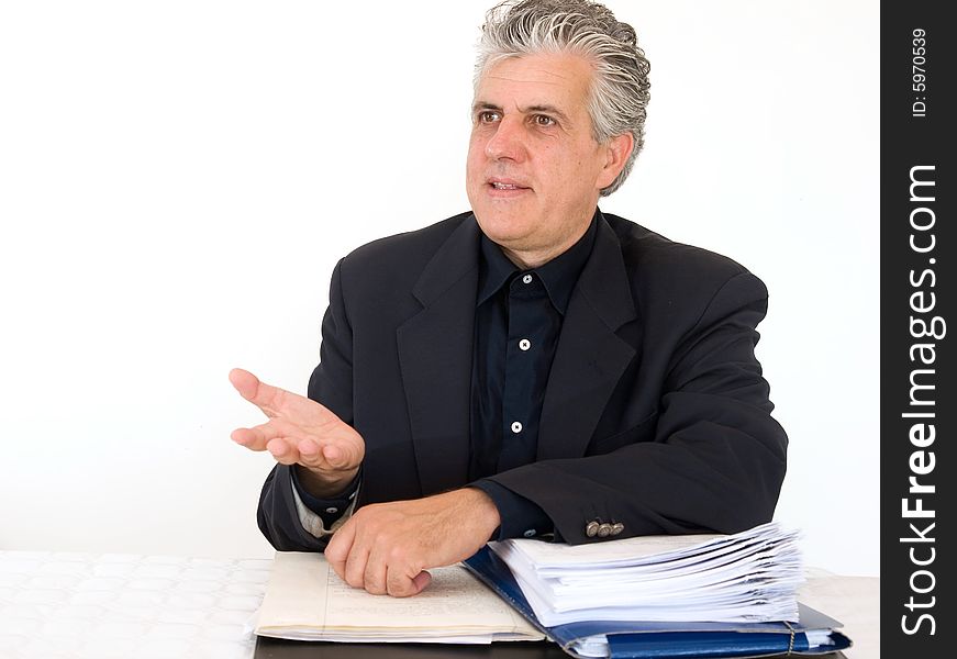 A businessman at work in his office in moment of the day.