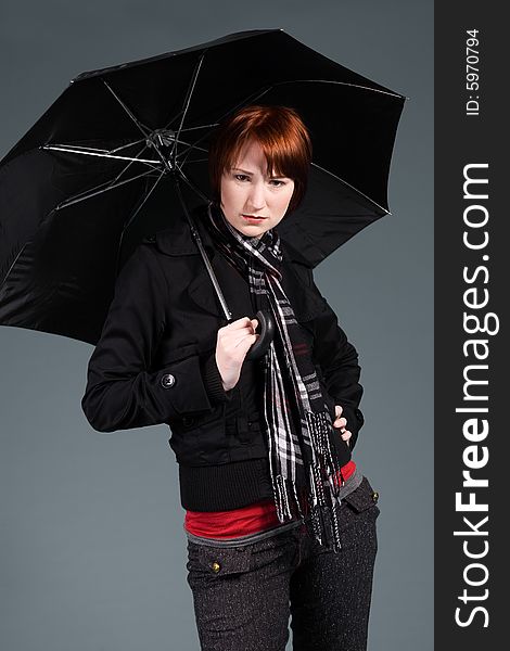 Young red haired girl with her umbrella. Young red haired girl with her umbrella