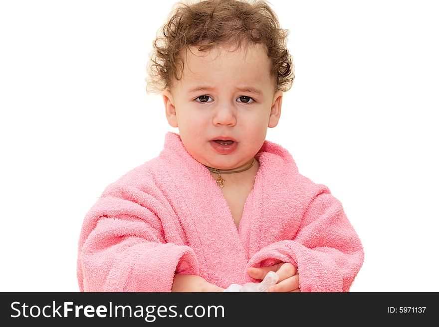 Small crying boy in a pink dressing gown