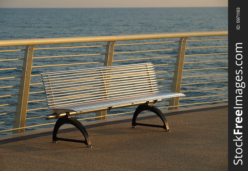 A relaxing shot of a bench in a dock. A relaxing shot of a bench in a dock