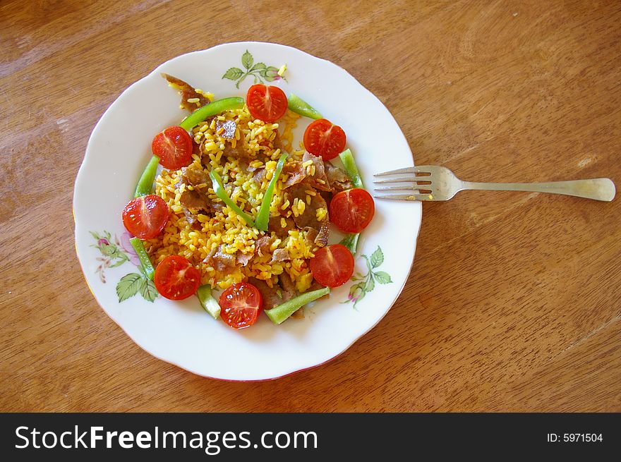 Decorated plate with meet, rice and vegetables. Decorated plate with meet, rice and vegetables