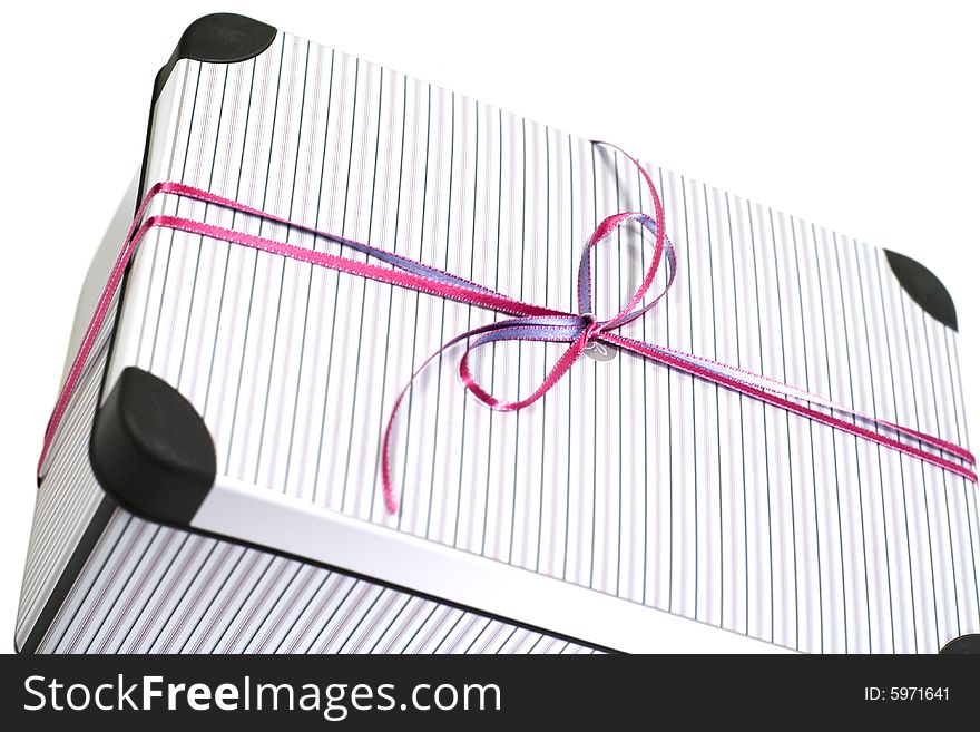 Close up of metal gift box with ribbon on white background