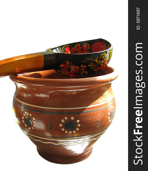 Russian earthenware glazed jug with wooden spoon. Russian earthenware glazed jug with wooden spoon