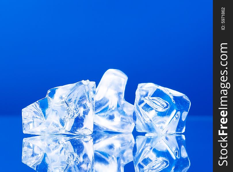 Close-up of ice cubes on blue