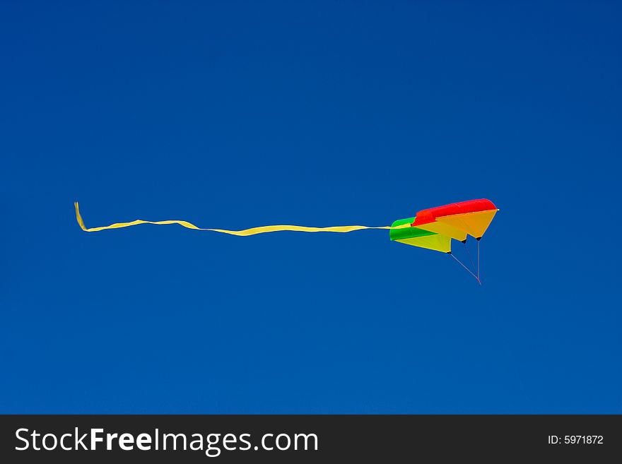 Kite over a blue sky on a beach