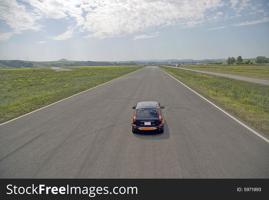 Small car on highway with.