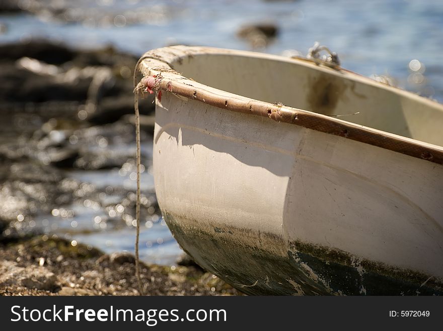 Old boat on the edge of a rocky beach