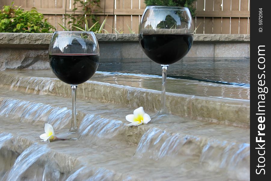 Set for a staycation with wine and plumeria petals in the backyard pool and suana. Set for a staycation with wine and plumeria petals in the backyard pool and suana.