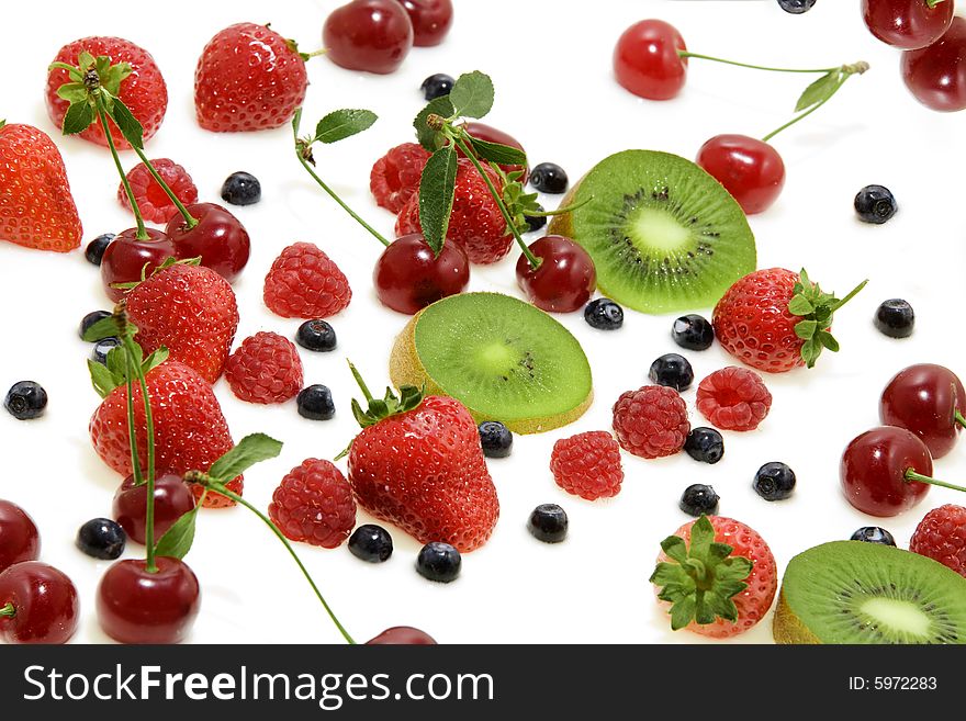 View of different kinds of berries on milky background. View of different kinds of berries on milky background