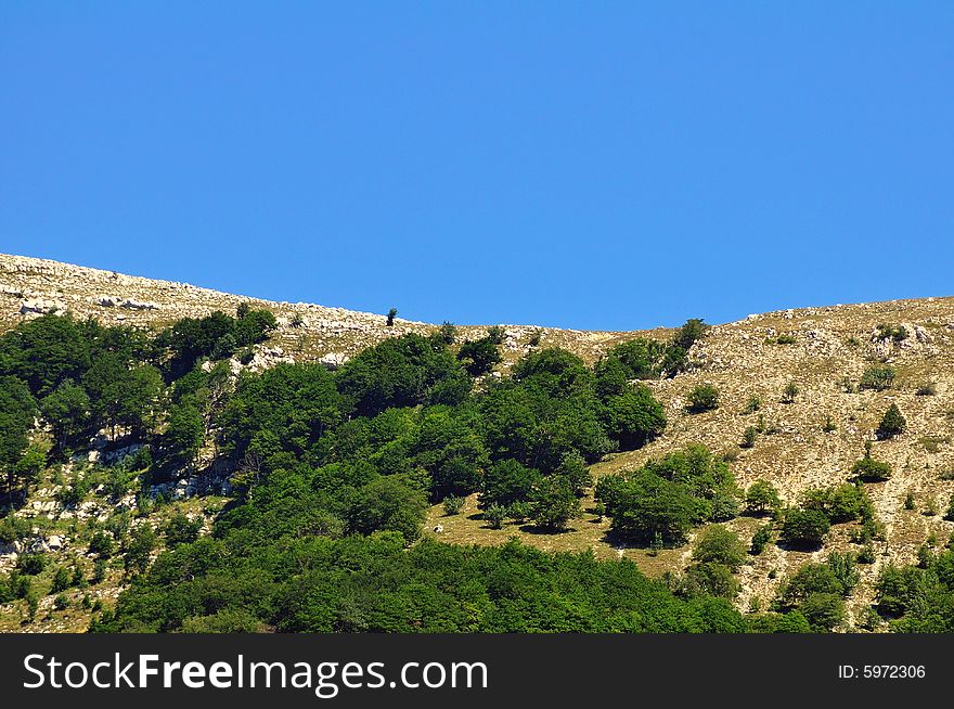 A clear detail of an apennines abruzzo mountain with bright azure sky. A clear detail of an apennines abruzzo mountain with bright azure sky