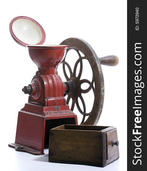 Red cast iron, antique Spanish Coffee Grinder with hand-cranked side wheel and wooden collection drawer