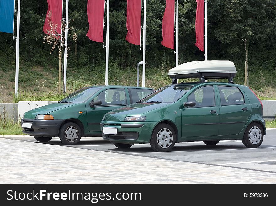 Green cars parked in a row