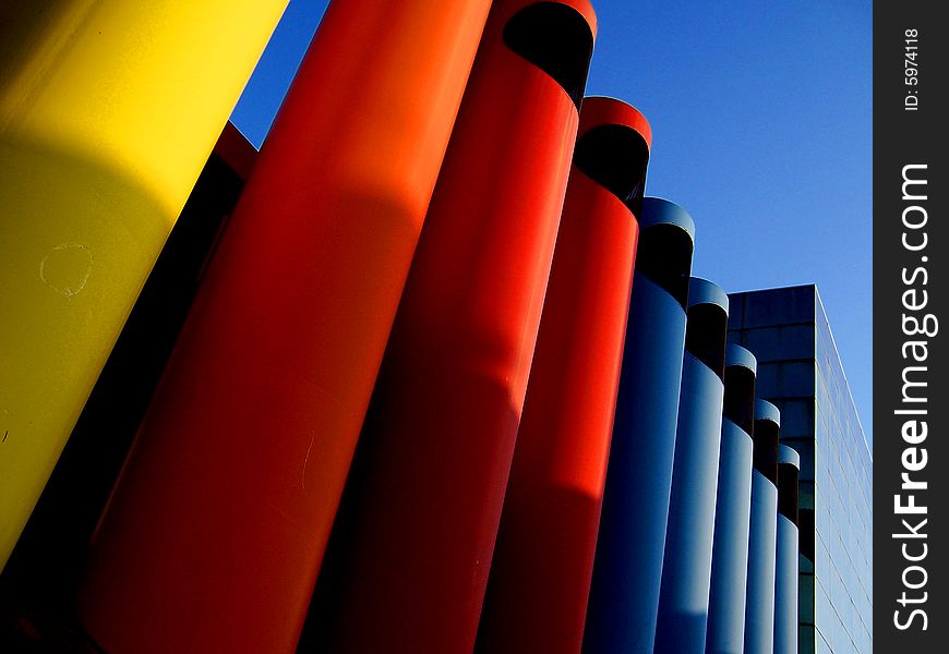 These colored tubes sit on a side street in Columbus, In. The color and style are unique to the towns identity.