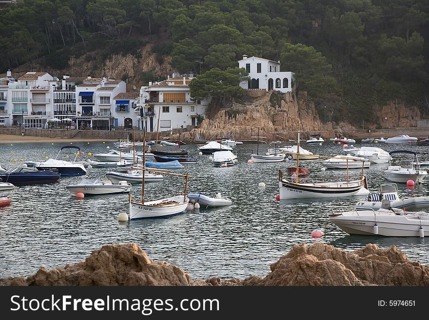 Boats in moored in Mediteranean cove at dawn