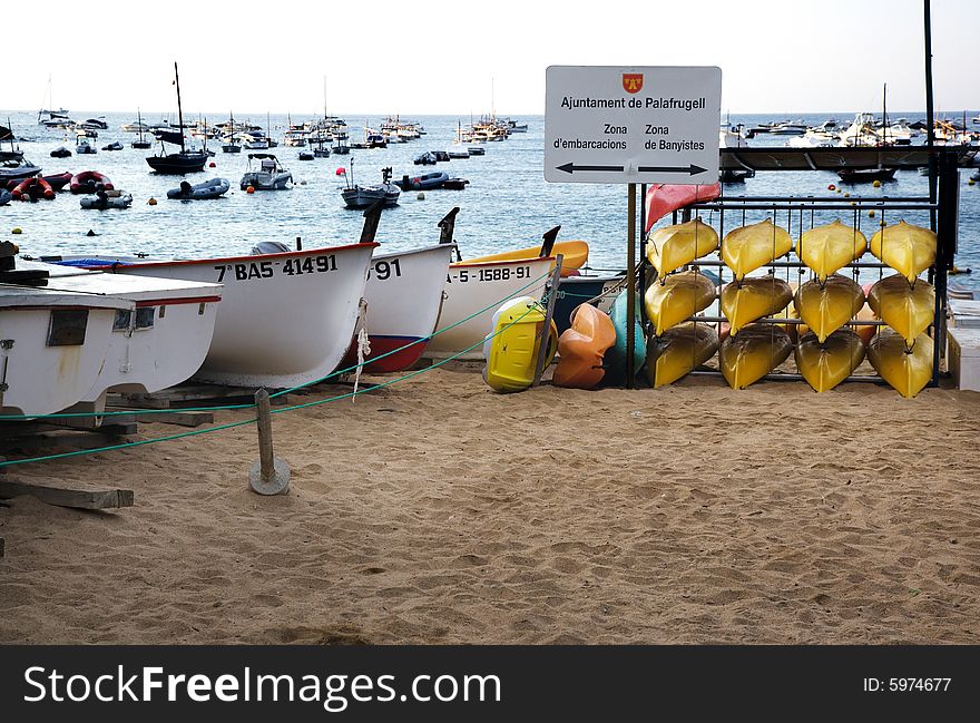 Kayaks and small boats pulled up in the embarkation zone on the Tamariu Costa Brava, Catalonia, Spain. Kayaks and small boats pulled up in the embarkation zone on the Tamariu Costa Brava, Catalonia, Spain
