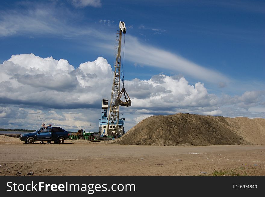 The port dredge unloads sand from the barge