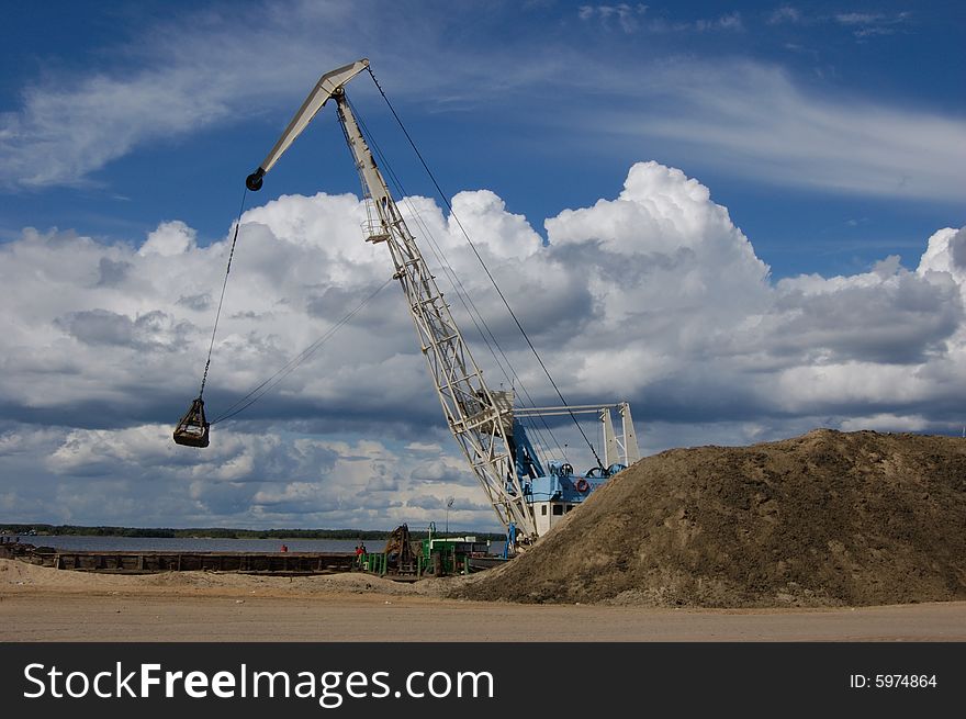 The port dredge unloads sand from the barge