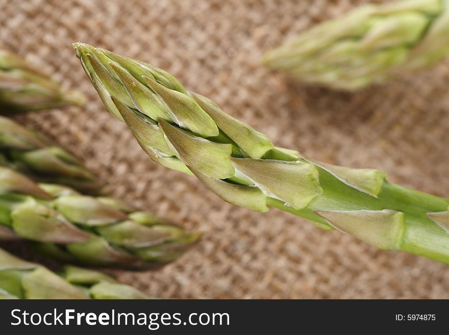 Fresh asparagus on hessian background, shallow DOF