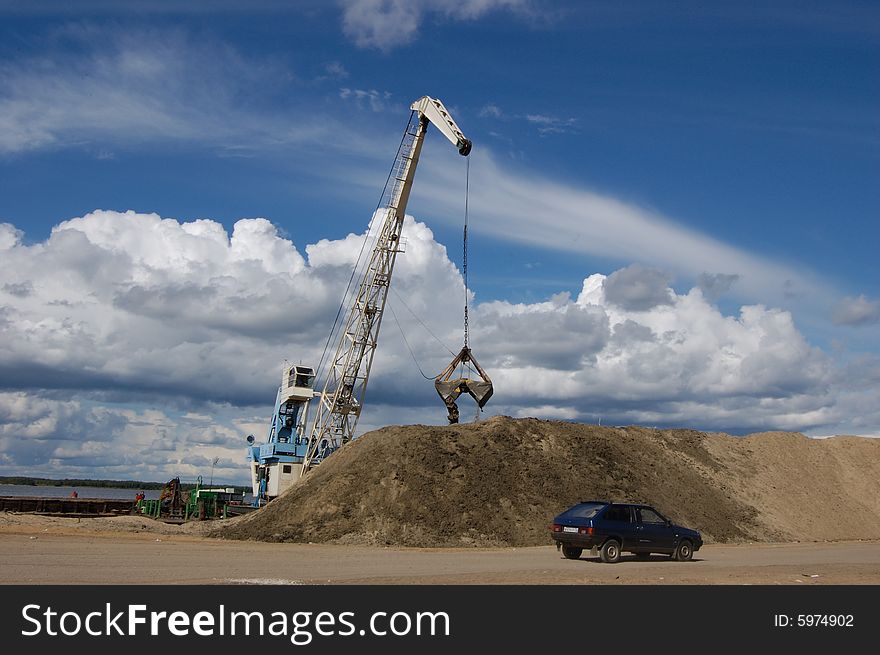 The port dredge unloads sand from the barge