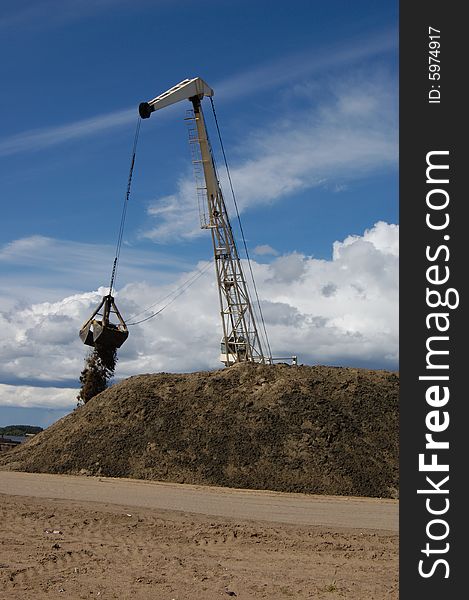 The port dredge unloads sand from the barge