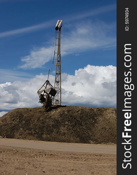 The port dredge unloads sand from the barge