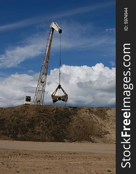 The port dredge unloads sand from the barge