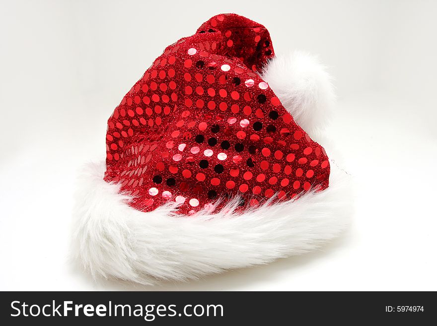 Santas hat on white, red glittering shingles on hat