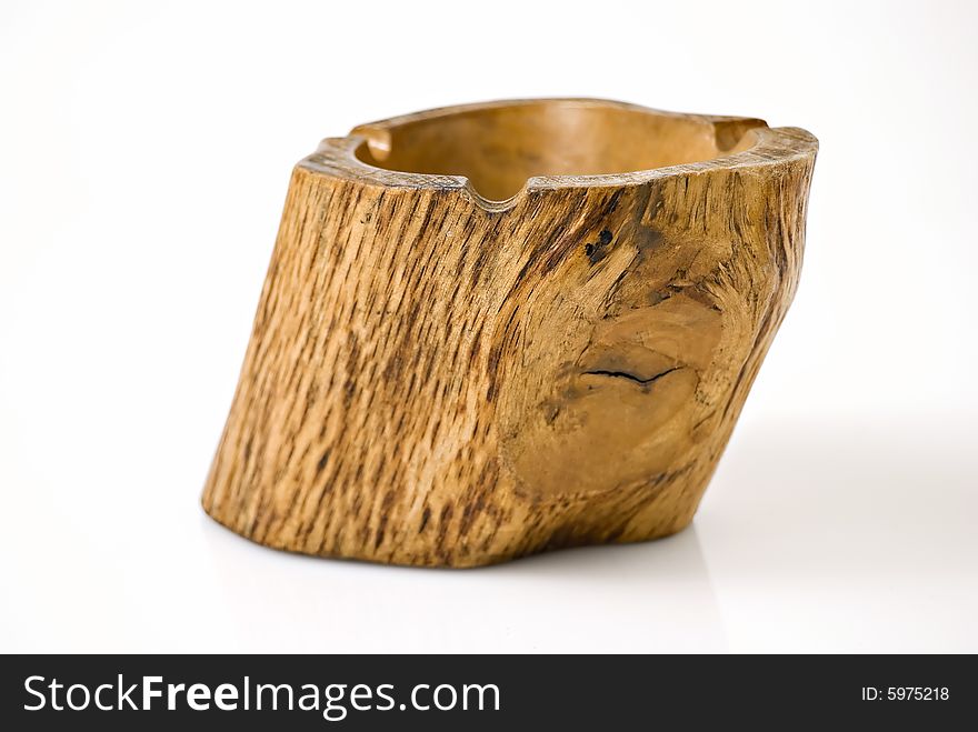 Closeup of wooden ashtray against white background