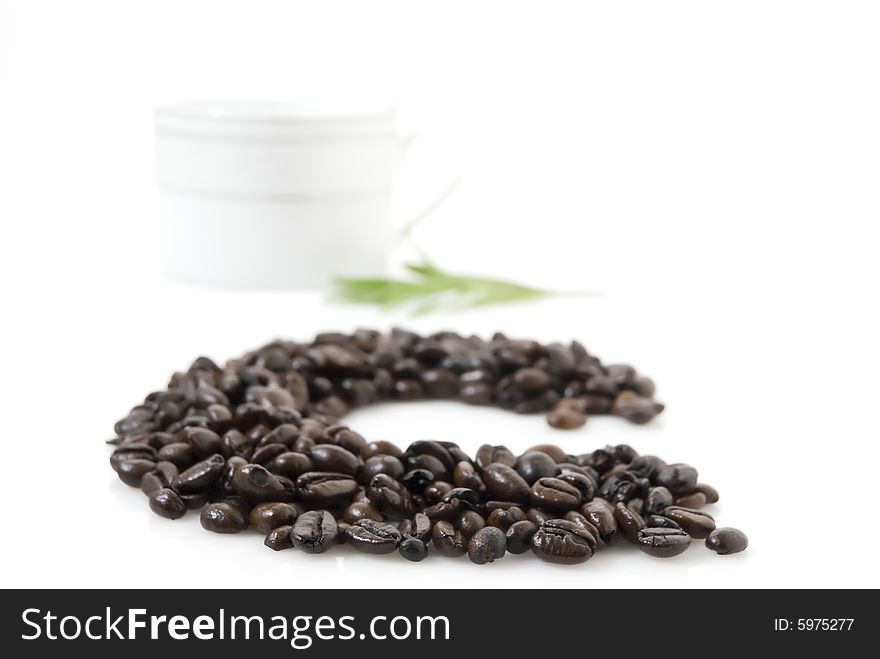 Closeup shot of letter C for coffee, against white background.  A cup and tarragon herb at background. Closeup shot of letter C for coffee, against white background.  A cup and tarragon herb at background.