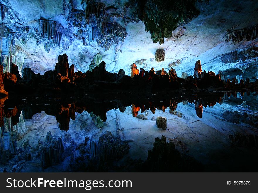 LuDiYan Cave, Guilin, China. Stalactites formed by nature though millions of years, reflected in the underground pool. LuDiYan Cave, Guilin, China. Stalactites formed by nature though millions of years, reflected in the underground pool
