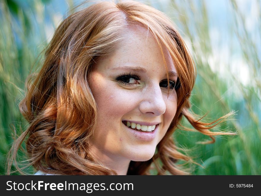 Girl Sitting In Field Of Grass - Horizontal