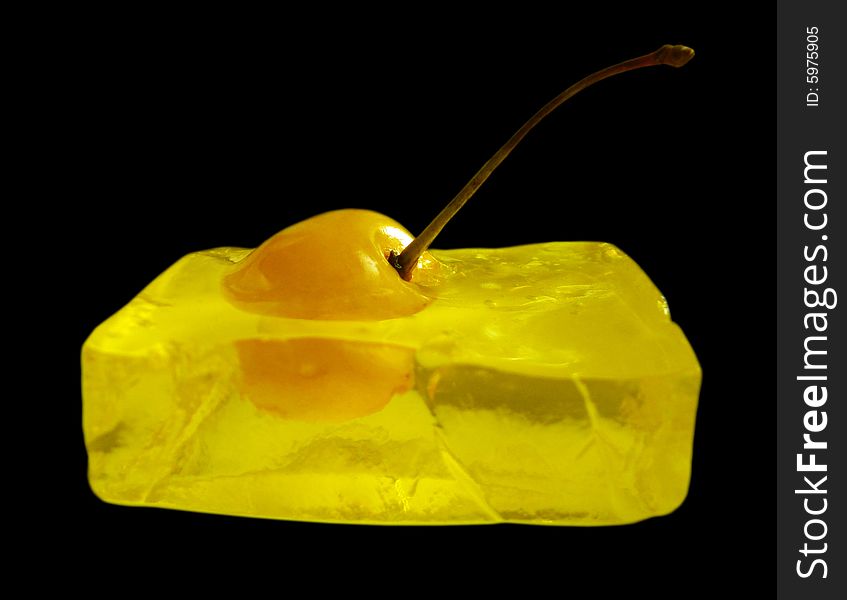 Yellow cherry frozen in jelled cube. Yellow cherry frozen in jelled cube