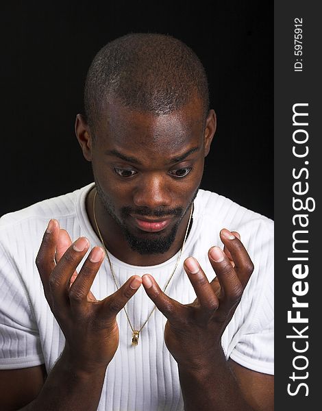 Afro-American man looking into his hands. Afro-American man looking into his hands.