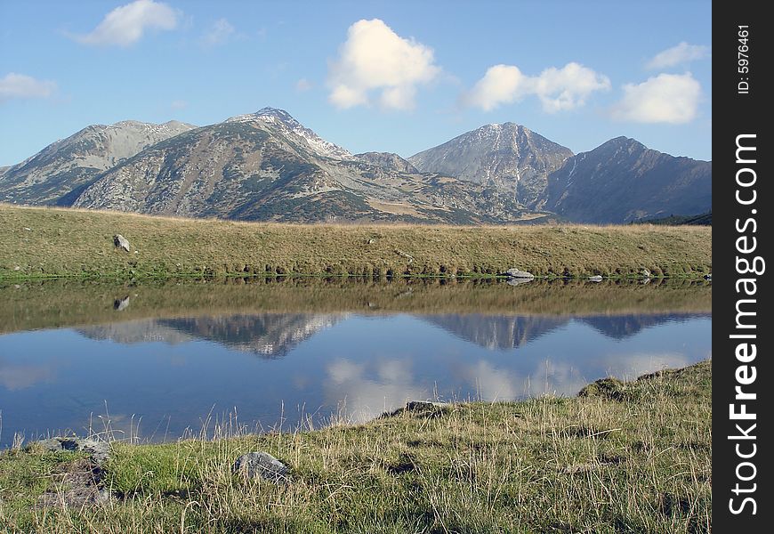 Mountain Range Reflected In The Water Retezat National Park. Mountain Range Reflected In The Water Retezat National Park.