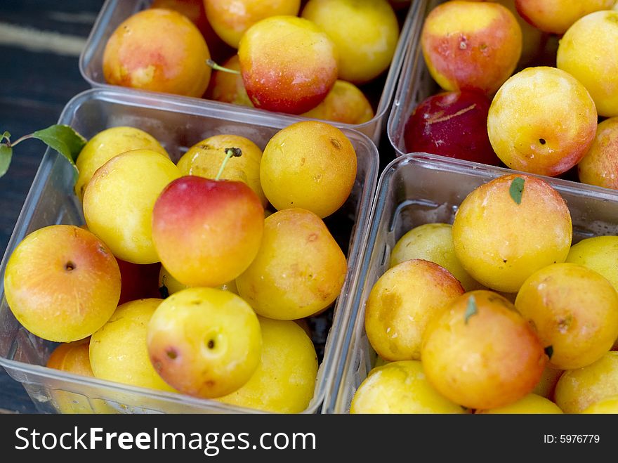 Close up shot of yellow and red Rainier cherries in clear plastic containers. Close up shot of yellow and red Rainier cherries in clear plastic containers.