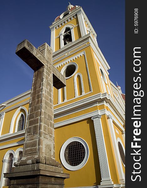 Stone cross next to the yellow cathedral in central Granada Nicaragua. Stone cross next to the yellow cathedral in central Granada Nicaragua