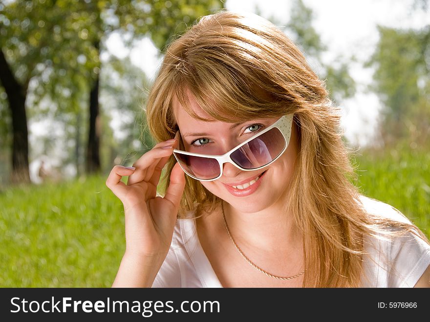 Cheerful blond girl in the park. Cheerful blond girl in the park