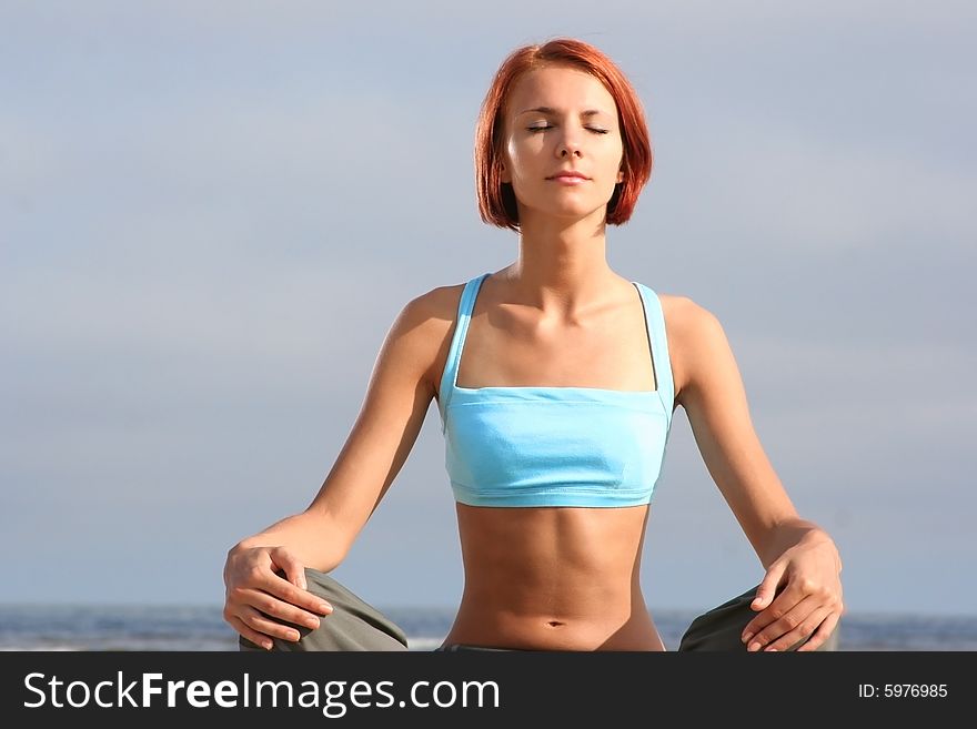 Young girl meditating on beach. Young girl meditating on beach