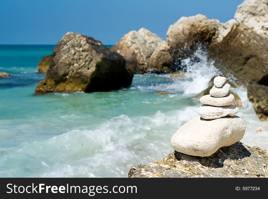 Stacked limestone pebbles on the beach, blurred background. Stacked limestone pebbles on the beach, blurred background