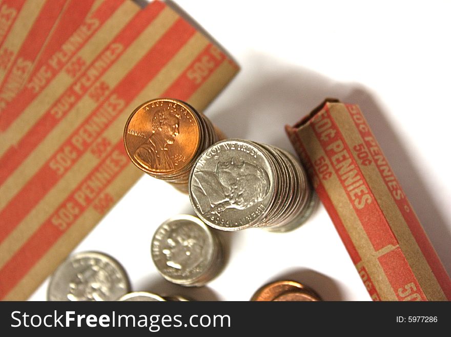 Loose change with penny rolls.  Focus on the higher stacks, pennies and nickels.